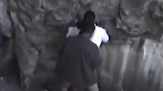 Guy fucks a black girl near rocks