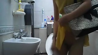 Spying a cute girl pee and wipe her pussy